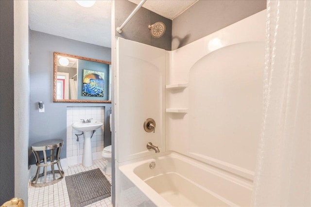 1713 S 5th St, Austin, TX 78704 - full bathroom with tile patterned floors, shower / tub combo, and tile walls