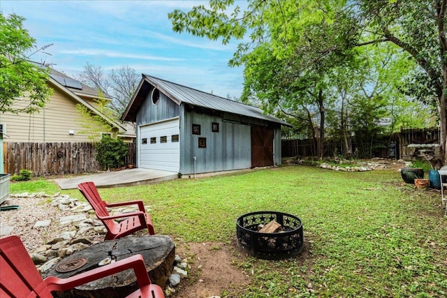 1713 S 5th St, Austin, TX 78704 - fenced backyard featuring a detached garage, an outdoor structure, and a fire pit