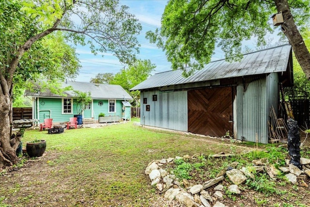 1713 S 5th St, Austin, TX 78704 - view of yard with an outdoor structure, an outdoor fire pit, and a detached garage