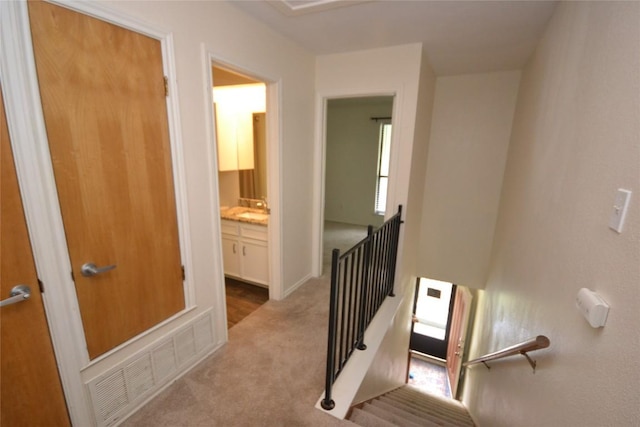 staircase with visible vents and carpet