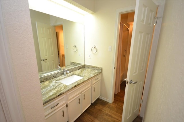 full bath with wood finished floors and vanity