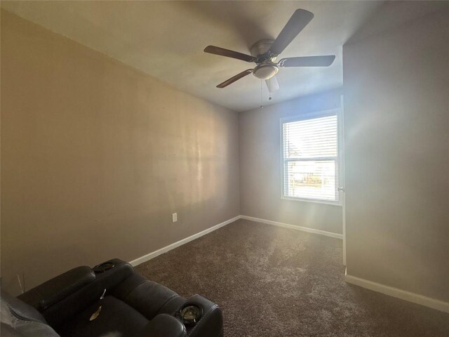 714 Miriam St, Baytown, TX 77520 - empty room with dark colored carpet, baseboards, and a ceiling fan