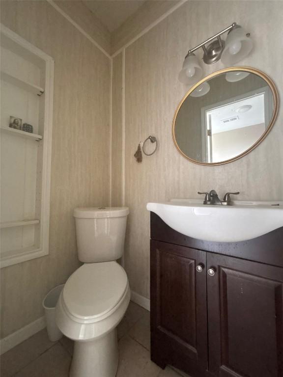 714 Miriam St, Baytown, TX 77520 - half bathroom with toilet, tile patterned flooring, and vanity
