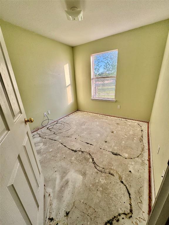 700 Lago Vista St, San Marcos, TX 78666 - spare room with a textured ceiling