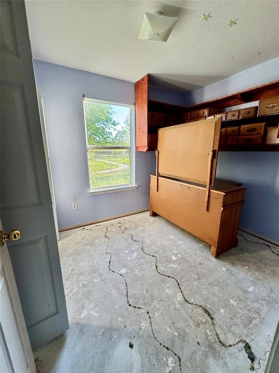 700 Lago Vista St, San Marcos, TX 78666 - spare room featuring a textured ceiling