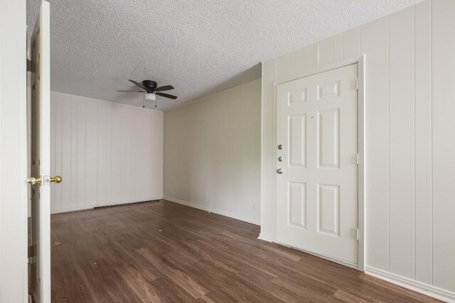 5300 Guadalupe St Unit 6202, Austin, TX 78751 - spare room with ceiling fan, wood finished floors, a decorative wall, and a textured ceiling