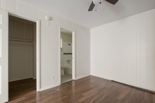 5300 Guadalupe St Unit 6202, Austin, TX 78751 - unfurnished bedroom featuring wood finished floors, a closet, a textured ceiling, a spacious closet, and ensuite bathroom