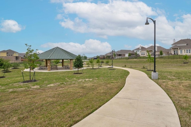 view of property's community with a gazebo, a residential view, and a lawn