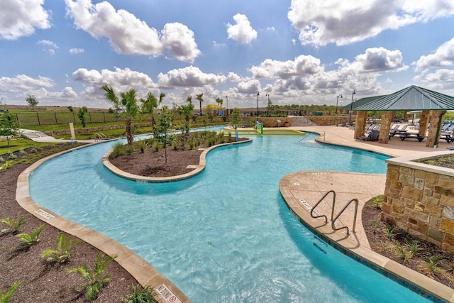 pool with a gazebo, a patio area, and fence
