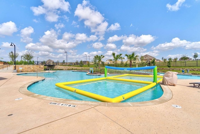 surrounding community featuring a swimming pool and fence