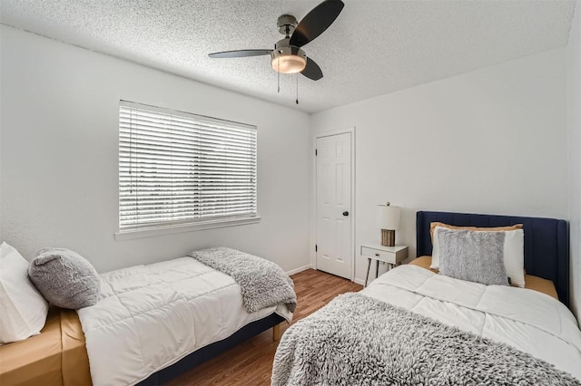 14487 Robert I Walker Blvd, Austin, TX 78728 - bedroom with a textured ceiling, wood finished floors, and ceiling fan