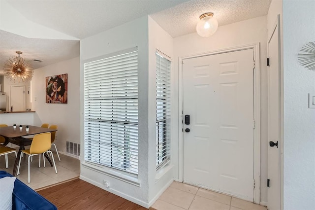 14487 Robert I Walker Blvd, Austin, TX 78728 - entrance foyer featuring light tile patterned flooring and a textured ceiling