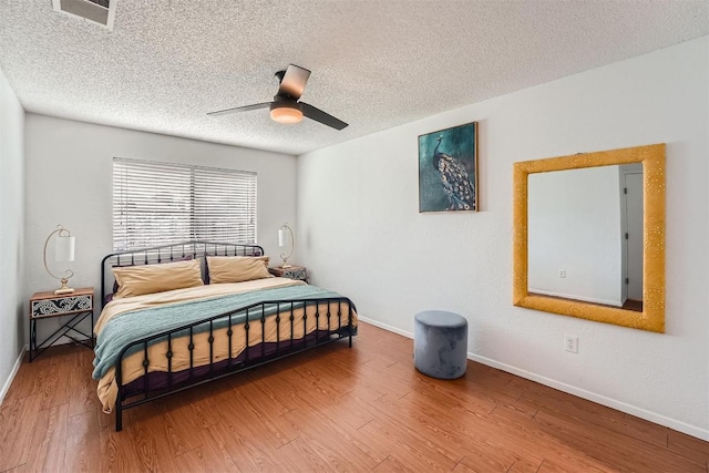 14487 Robert I Walker Blvd, Austin, TX 78728 - bedroom with wood finished floors, a textured ceiling, and a ceiling fan