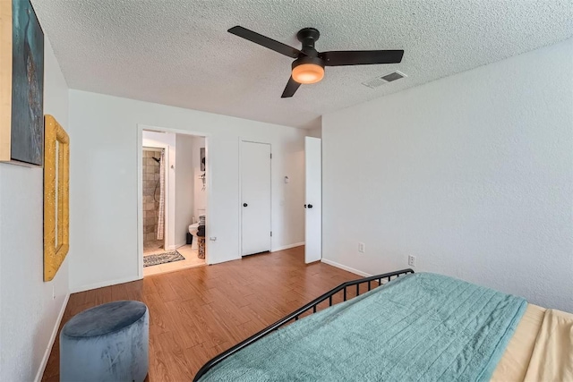 14487 Robert I Walker Blvd, Austin, TX 78728 - bedroom with wood finished floors, a textured ceiling, a ceiling fan, and ensuite bathroom