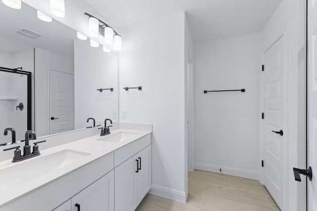 13320 Lapoynor St, Manor, TX 78653 - full bathroom with double vanity, a shower with shower door, and tile patterned floors