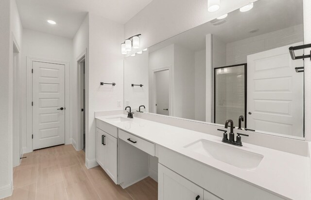 12104 Bacalar Bnd, Manor, TX 78653 - full bathroom featuring double vanity, a shower stall, and recessed lighting