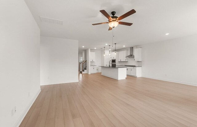 12104 Bacalar Bnd, Manor, TX 78653 - unfurnished living room with recessed lighting, a ceiling fan, and light wood-style floors