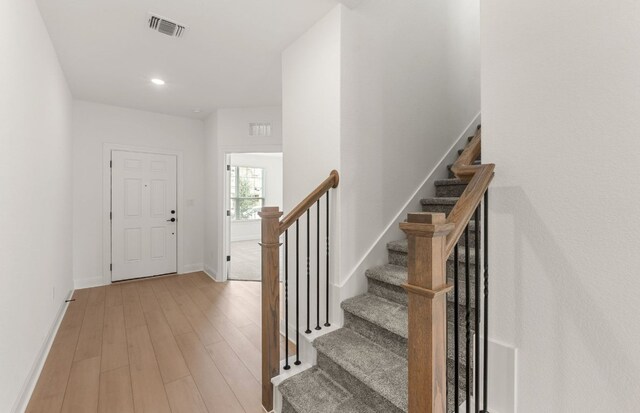 12104 Bacalar Bnd, Manor, TX 78653 - foyer entrance with light wood-style flooring, stairway, and recessed lighting