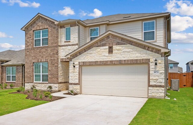 16724 Santiaguillo Trce, Manor, TX 78653 - view of front of property with stone siding, concrete driveway, and an attached garage