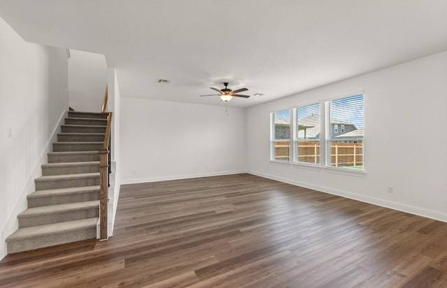 16724 Santiaguillo Trce, Manor, TX 78653 - unfurnished living room featuring stairs, ceiling fan, and wood finished floors
