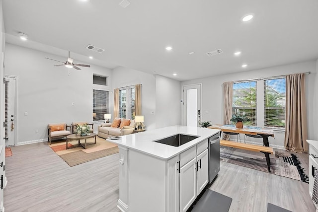 8522 Leroi Dr, Austin, TX 78744 - kitchen featuring light wood finished floors, recessed lighting, light countertops, open floor plan, and dishwasher