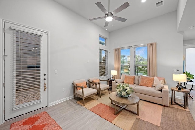 8522 Leroi Dr, Austin, TX 78744 - living area with light wood finished floors, a ceiling fan, a high ceiling, and recessed lighting