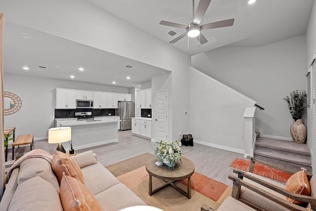 8522 Leroi Dr, Austin, TX 78744 - living area featuring stairway, recessed lighting, light wood-type flooring, and a ceiling fan