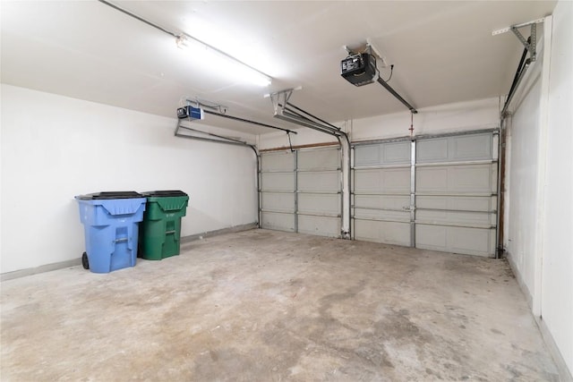 15406 Ecorio Dr, Austin, TX 78728 - garage featuring a garage door opener and baseboards