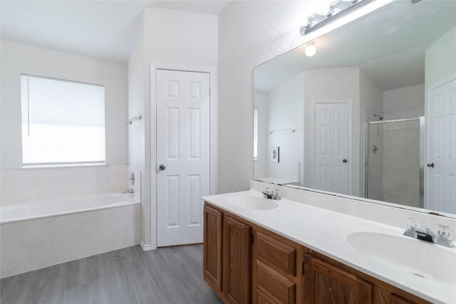 15406 Ecorio Dr, Austin, TX 78728 - full bath featuring wood finished floors, a bath, a stall shower, and double vanity