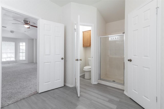 15406 Ecorio Dr, Austin, TX 78728 - full bath featuring toilet, a shower stall, a ceiling fan, and wood finished floors