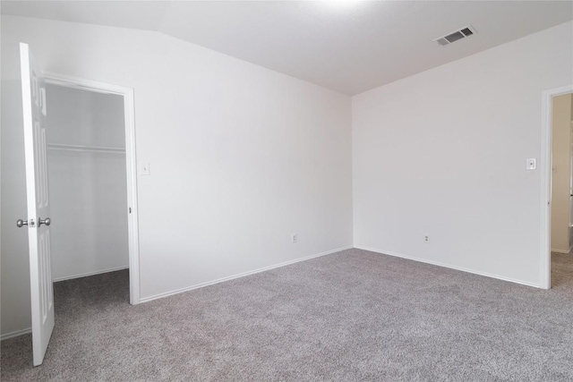 15406 Ecorio Dr, Austin, TX 78728 - unfurnished bedroom featuring a walk in closet, carpet floors, vaulted ceiling, a closet, and baseboards