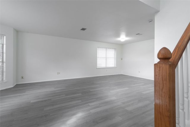 15406 Ecorio Dr, Austin, TX 78728 - empty room featuring dark wood-style floors, baseboards, and stairway