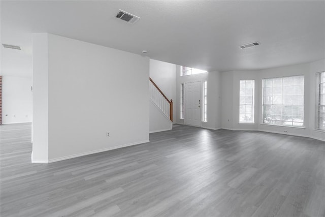 15406 Ecorio Dr, Austin, TX 78728 - unfurnished living room featuring wood finished floors, baseboards, and stairs