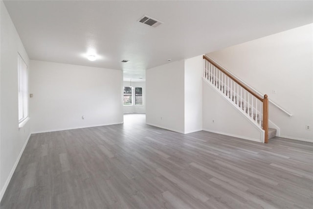 15406 Ecorio Dr, Austin, TX 78728 - unfurnished living room featuring wood finished floors, stairway, and baseboards