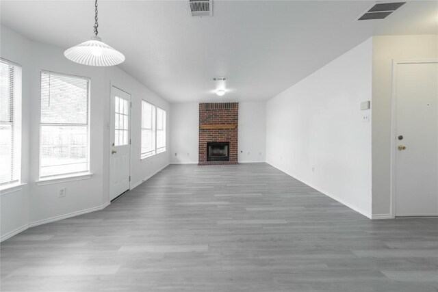 15406 Ecorio Dr, Austin, TX 78728 - unfurnished living room featuring wood finished floors, baseboards, and a fireplace