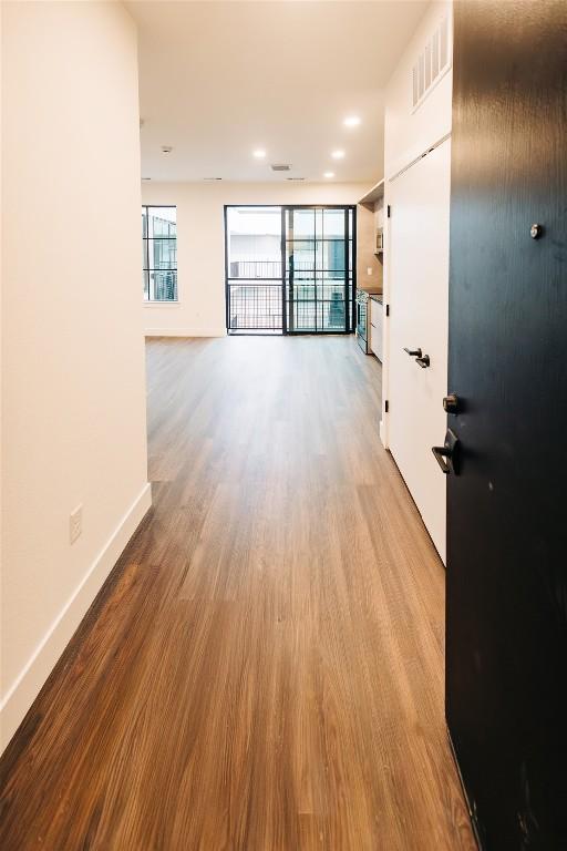 4315 S Congress Ave Unit 520, Austin, TX 78745 - interior space with a wealth of natural light, visible vents, baseboards, and wood finished floors