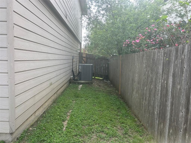 view of yard featuring central AC unit and a fenced backyard