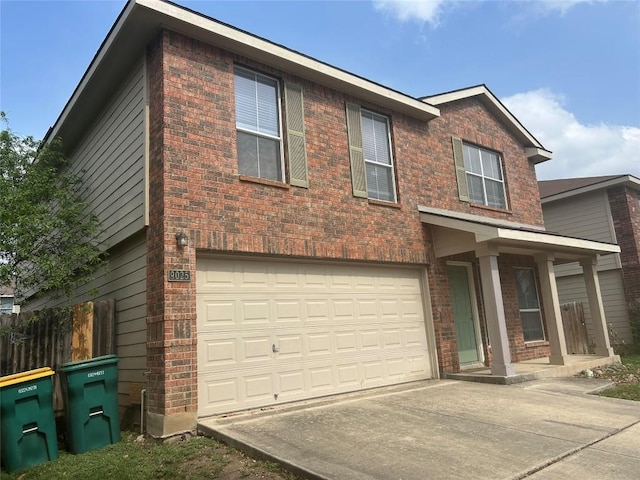 view of front of home with an attached garage, driveway, and brick siding