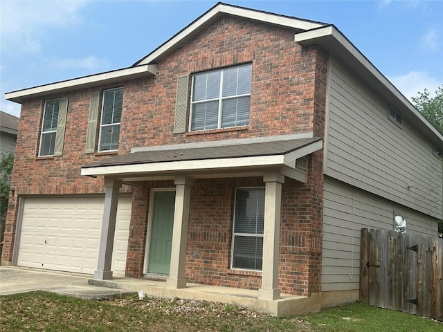 traditional home with brick siding, driveway, fence, and a garage