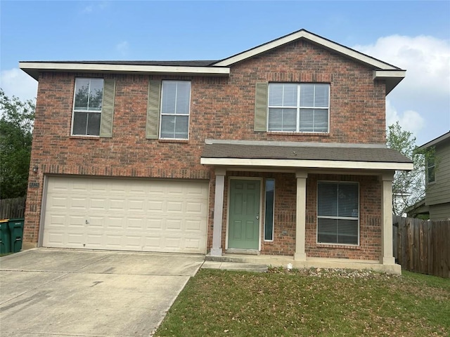 traditional home with driveway, fence, and brick siding