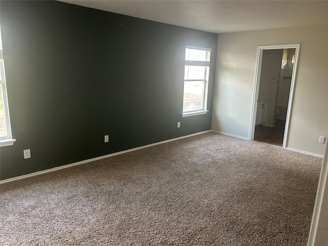 carpeted spare room with baseboards