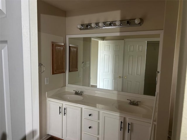 bathroom with a sink and double vanity