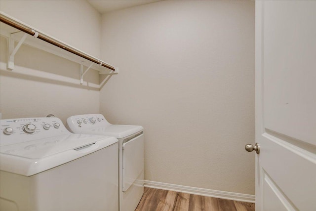 105 Saviano Rd, Hutto, TX 78634 - laundry area featuring washing machine and clothes dryer, baseboards, and light wood finished floors