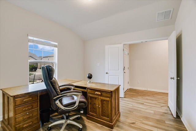 105 Saviano Rd, Hutto, TX 78634 - home office featuring lofted ceiling, light wood-style flooring, and baseboards