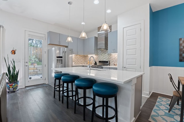 8922 Menchaca Rd Unit 204, Austin, TX 78748 - kitchen with light countertops, a breakfast bar area, dark wood finished floors, wall chimney range hood, and backsplash
