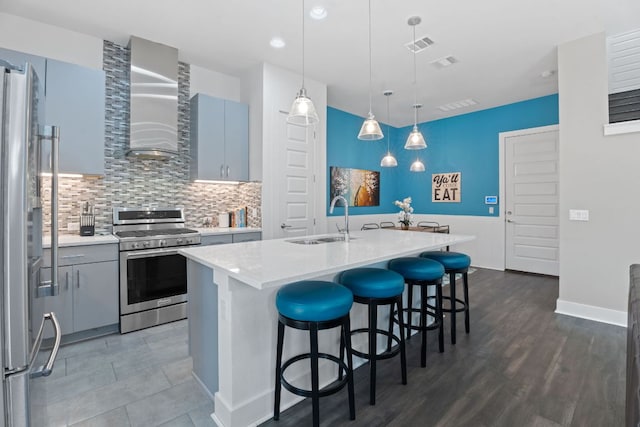 8922 Menchaca Rd Unit 204, Austin, TX 78748 - kitchen featuring stainless steel appliances, a sink, wall chimney range hood, light countertops, and backsplash
