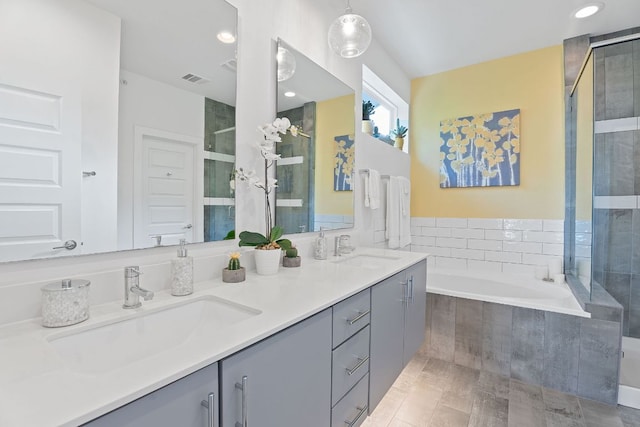 8922 Menchaca Rd Unit 204, Austin, TX 78748 - bathroom featuring a stall shower, a garden tub, double vanity, and recessed lighting