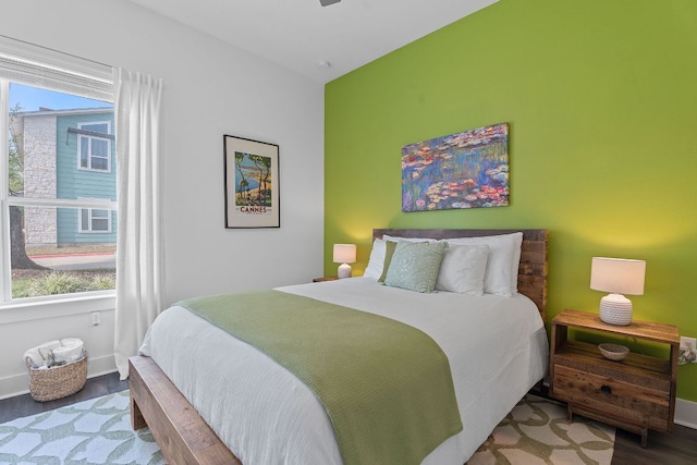 8922 Menchaca Rd Unit 204, Austin, TX 78748 - bedroom featuring multiple windows, wood finished floors, and baseboards