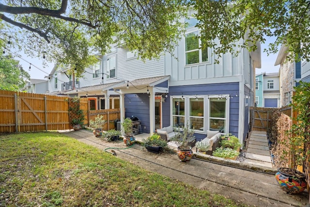 8922 Menchaca Rd Unit 204, Austin, TX 78748 - back of property with board and batten siding and a patio area