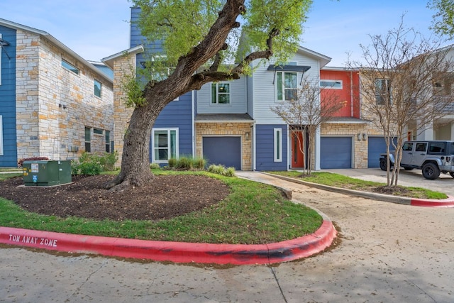 8922 Menchaca Rd Unit 204, Austin, TX 78748 - townhome / multi-family property featuring a garage, stone siding, and driveway